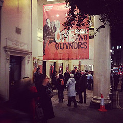 Just outside one of the many theatres where Richard Bean's One Man, Two Guvnors (2011) has appeared. This photo is the Theatre Royal, Haymarket, where it's currently running, just after it opened in March 2012. Photo by Paul-in-London.